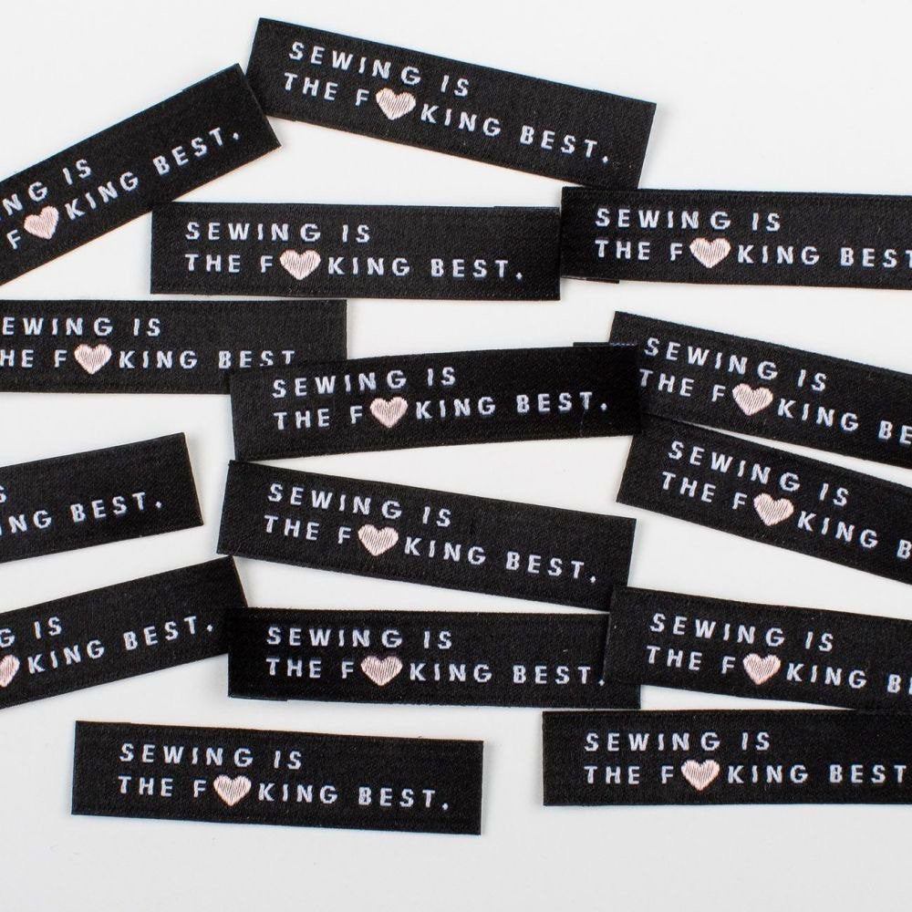 Bold 'Sewing is The F*cking Best' woven garment label with pink heart - premium quality sewing tags for handmade projects