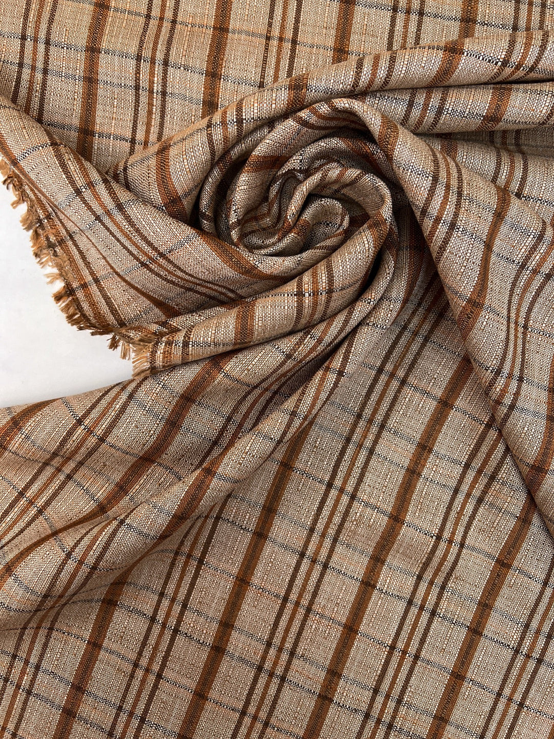 Italian plaid tweed fabric in browns and beige, viscose cotton blend, lightweight textile for structured coats, suiting, skirts, and dresses.