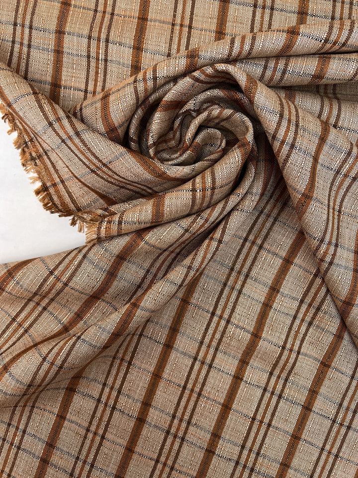 Italian plaid tweed fabric in browns and beige, viscose cotton blend, lightweight textile for structured coats, suiting, skirts, and dresses.