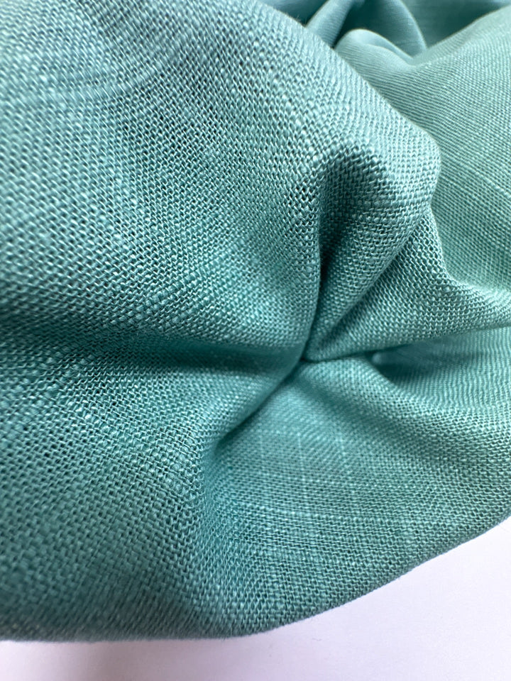 Linen Blend Shirting fabric in aqua blue-green color. Made from 78% Linen and 22% Rayon/Viscose. Ideal for shirts and blouses.