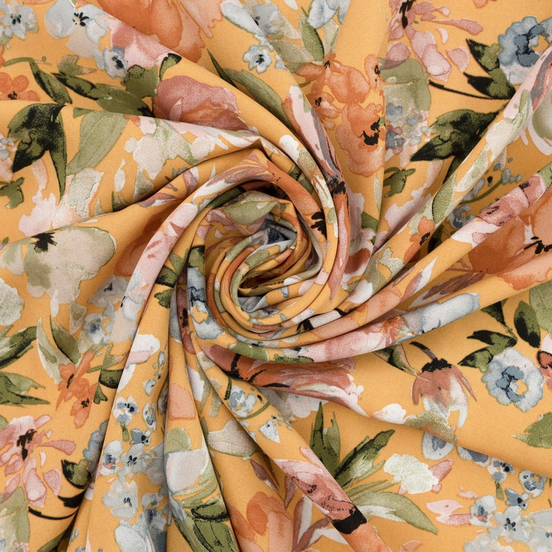 Rayon Poplin Golden Sunset Bloom fabric with marigold base, pumpkin, blue, and olive floral accents – 100% rayon sewing material