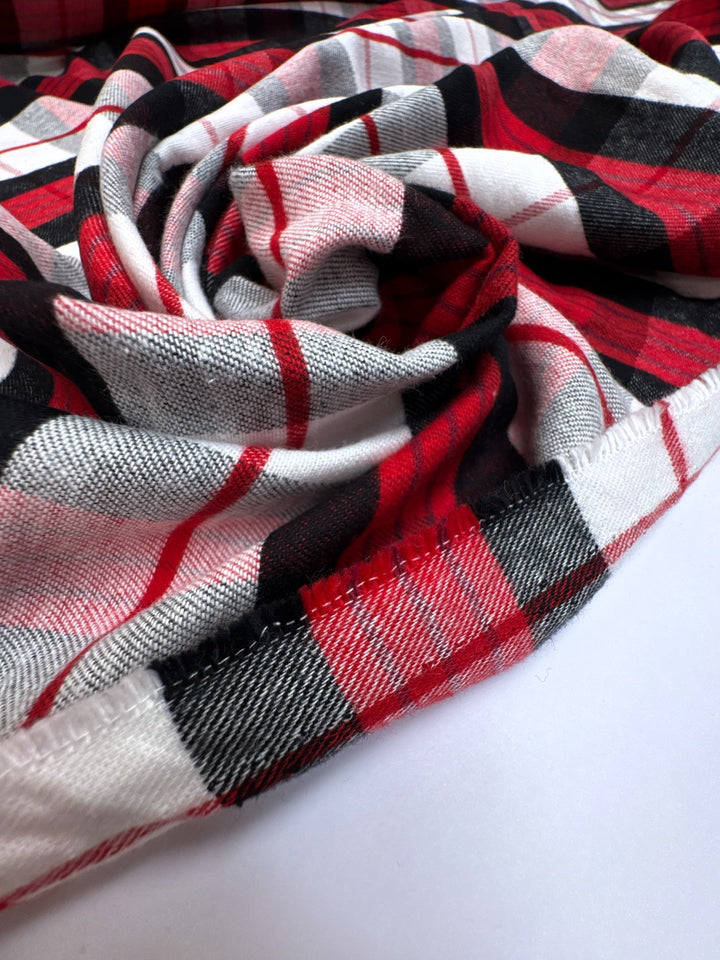 Italian cotton flannel fabric in large white, black, and red plaid, lightweight textile ideal for shirts, blouses, and casual wear.