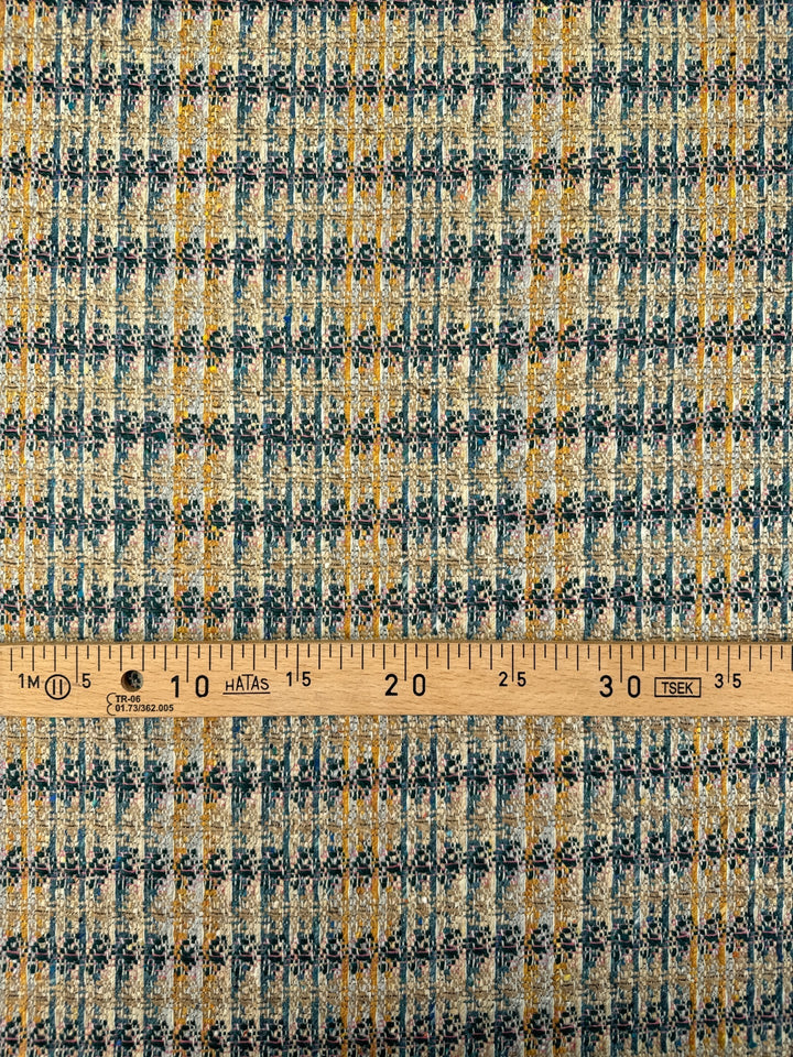 Italian tweed fabric with abstract plaid in beige, blue, and yellow tones, cotton wool blend, perfect for structured coats, suiting, and dresses.