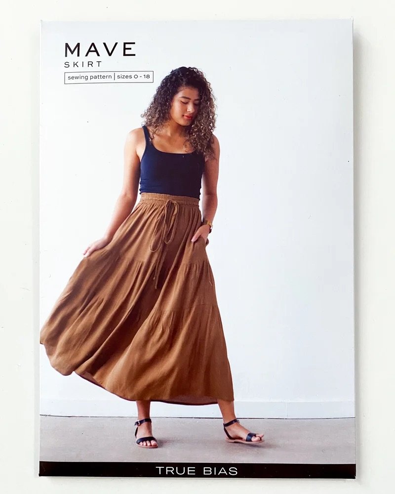 True Bias Mave Skirt sewing pattern in lightweight drapey fabric, featuring elastic waist, drawstring, inseam pockets, and optional ruffle hem in various lengths.