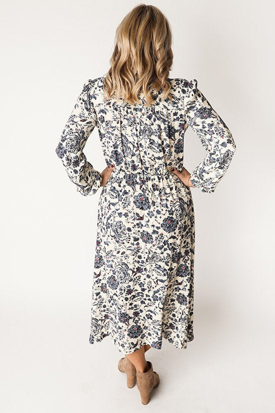 Chalk & Notch Orchid Midi Dress sewing pattern featuring wrap bodice, flowing midi skirt, and sleeve options with ruffle or long gathered sleeves.