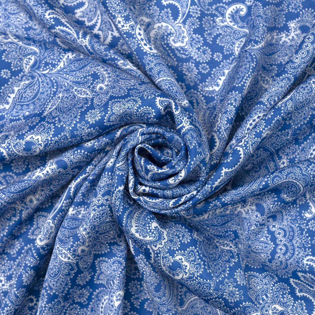 Viscose Twill fabric in cobalt blue and white paisley print, lightweight and silk-like for dressmaking
