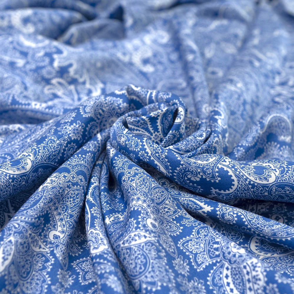 Viscose Twill fabric in cobalt blue and white paisley print, lightweight and silk-like for dressmaking