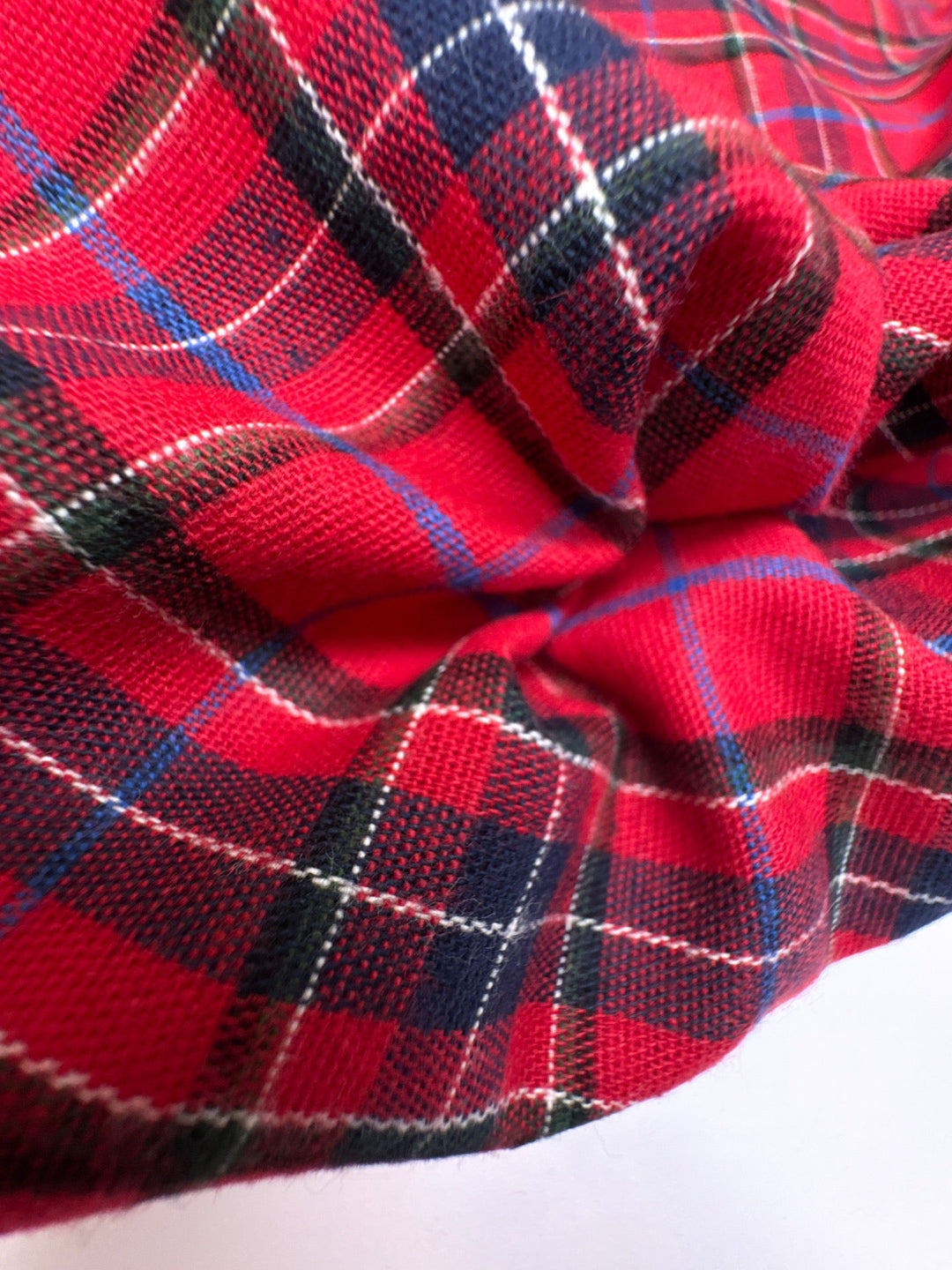 Italian cotton flannel fabric in bright red and black plaid, lightweight textile for shirts, blouses, and casual wear.
