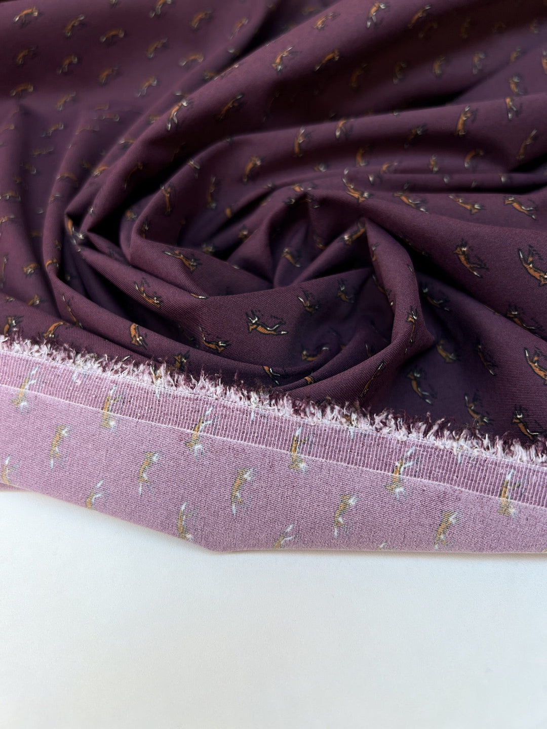 Dressweight Woven fabric in eggplant purple with tiny fox motifs. Made from 95% Polyamide and 5% Elastane. Ideal for dresses, skirts, and blouses.