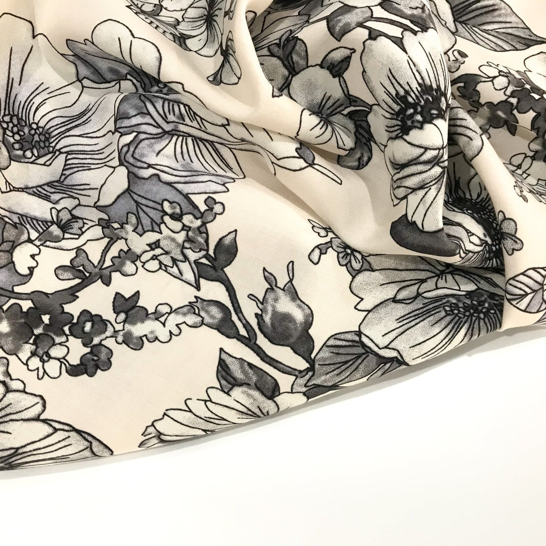 Rayon Challis Graphite Floral fabric with grayscale floral pattern on cream background, soft and lightweight for sewing projects