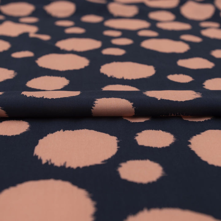Rayon Challis fabric in navy with random coral dots, lightweight and drapey textile for sewing blouses, dresses, and skirts