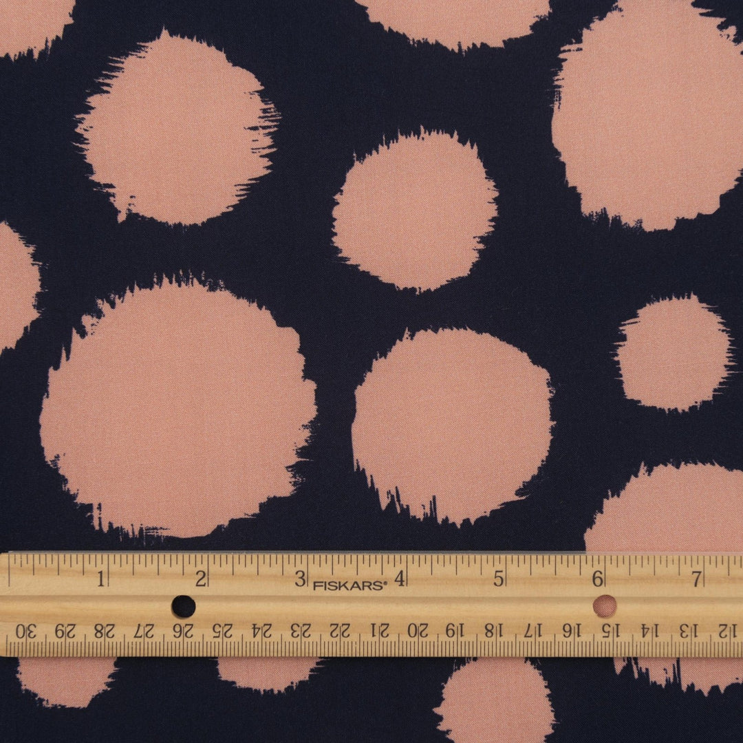 Rayon Challis fabric in navy with random coral dots, lightweight and drapey textile for sewing blouses, dresses, and skirts