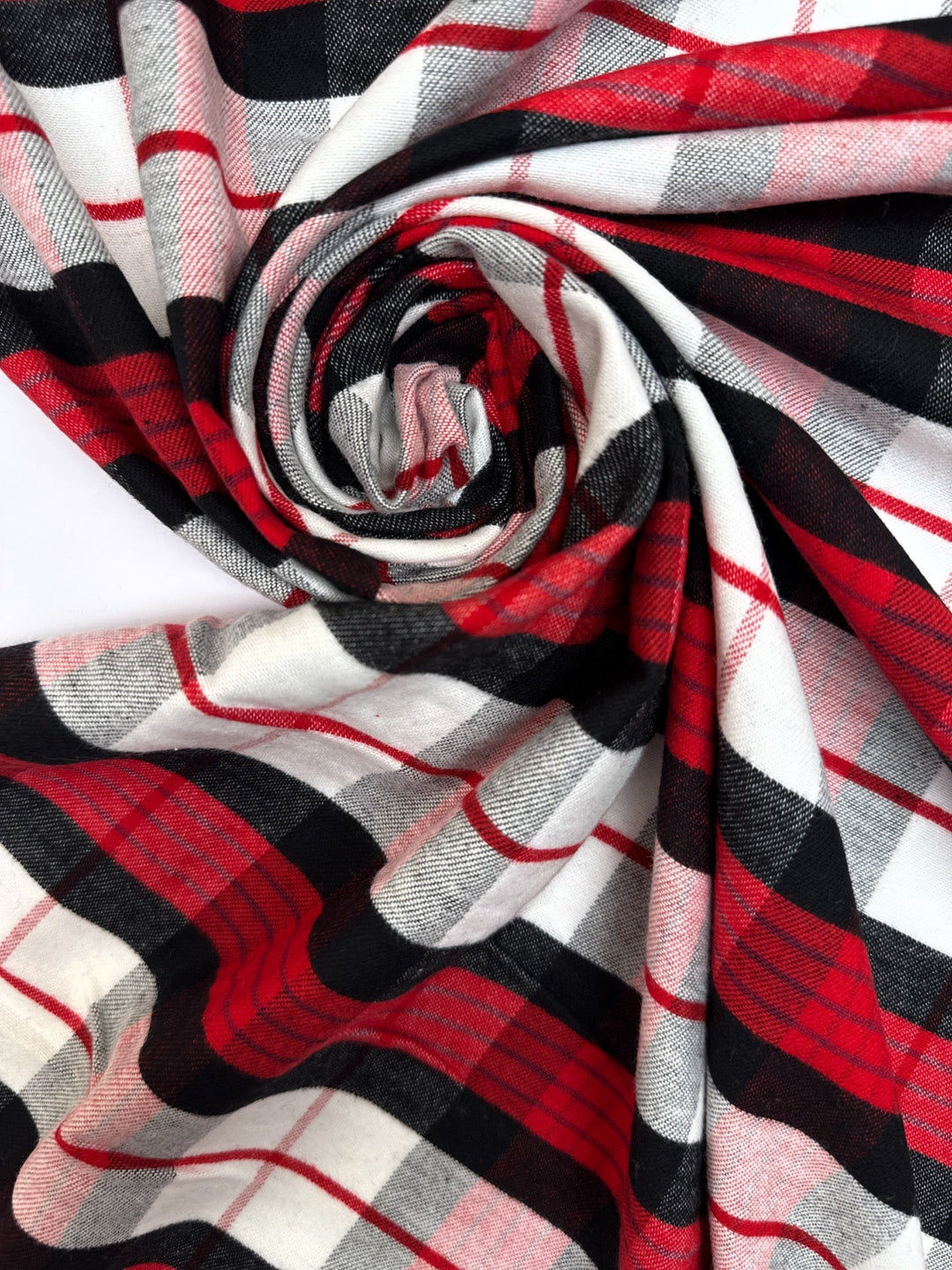 Italian cotton flannel fabric in large white, black, and red plaid, lightweight textile ideal for shirts, blouses, and casual wear.