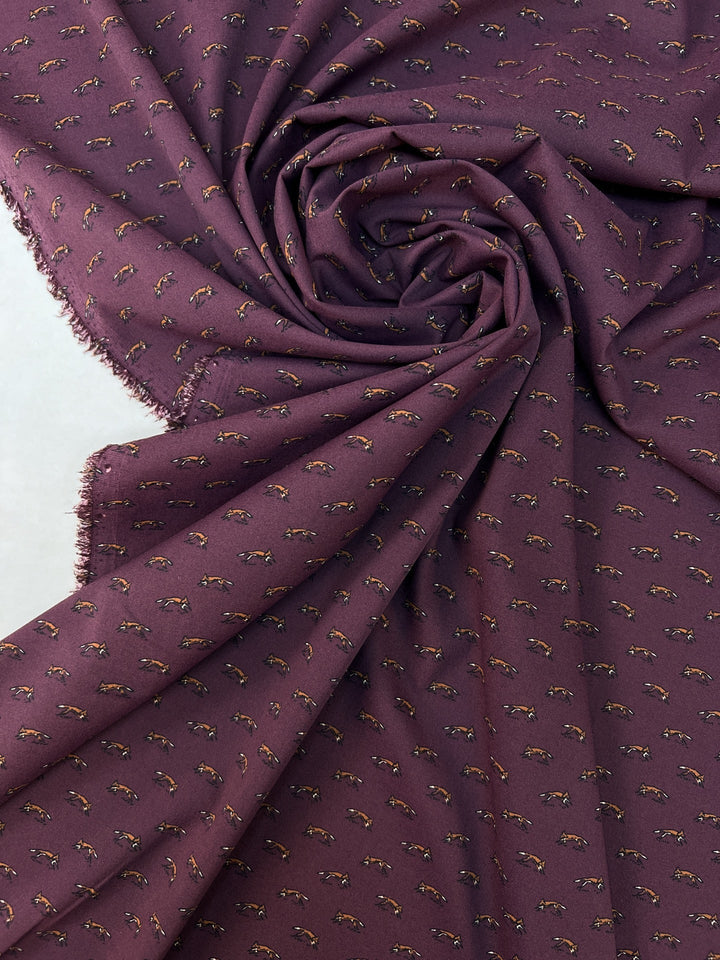 Dressweight Woven fabric in eggplant purple with tiny fox motifs. Made from 95% Polyamide and 5% Elastane. Ideal for dresses, skirts, and blouses.