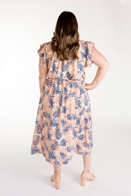 Chalk & Notch Orchid Midi Dress sewing pattern featuring wrap bodice, flowing midi skirt, and sleeve options with ruffle or long gathered sleeves.
