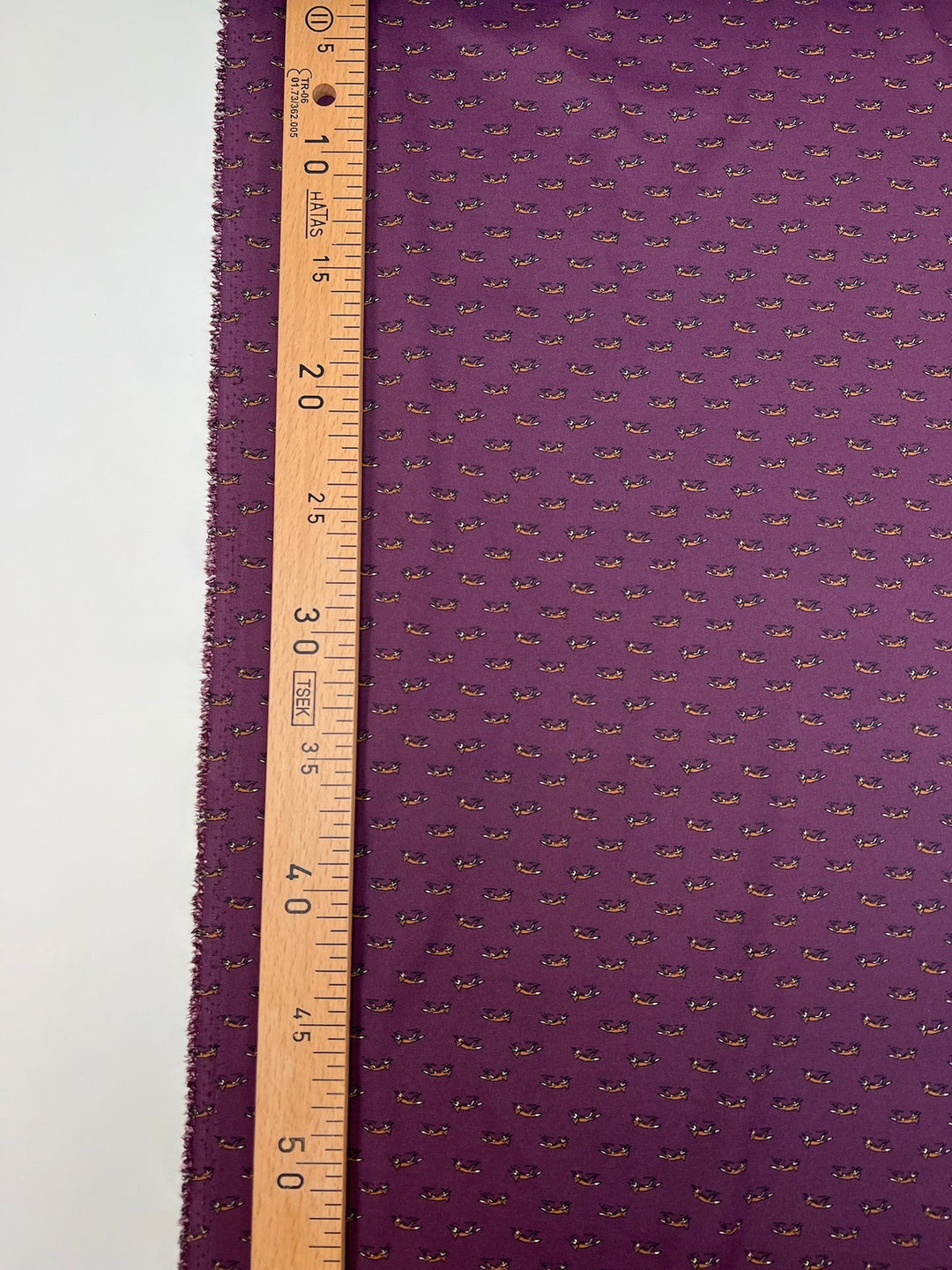 Dressweight Woven fabric in eggplant purple with tiny fox motifs. Made from 95% Polyamide and 5% Elastane. Ideal for dresses, skirts, and blouses.