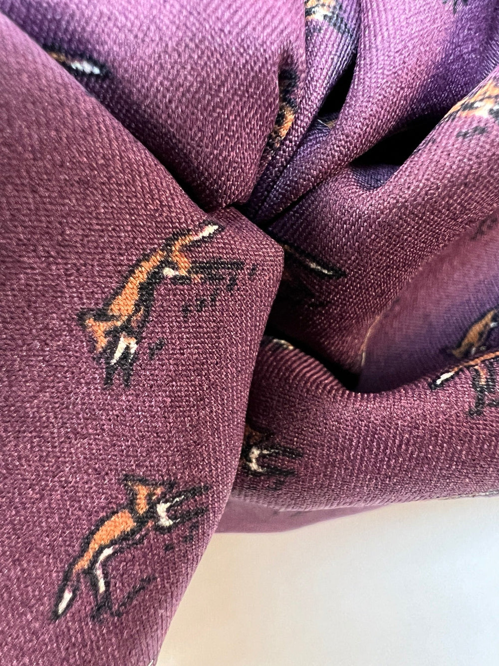 Dressweight Woven fabric in eggplant purple with tiny fox motifs. Made from 95% Polyamide and 5% Elastane. Ideal for dresses, skirts, and blouses.