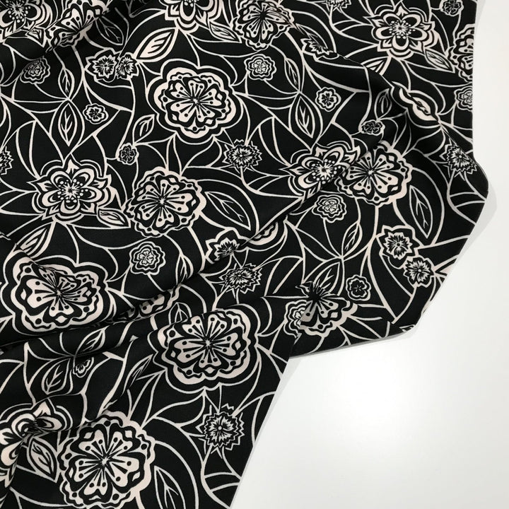 Organic Tencel Twill Rowdy Patch Black fabric with whimsical digital print, eco-friendly GOTS-certified inks, fluid drape, and luxury twill texture