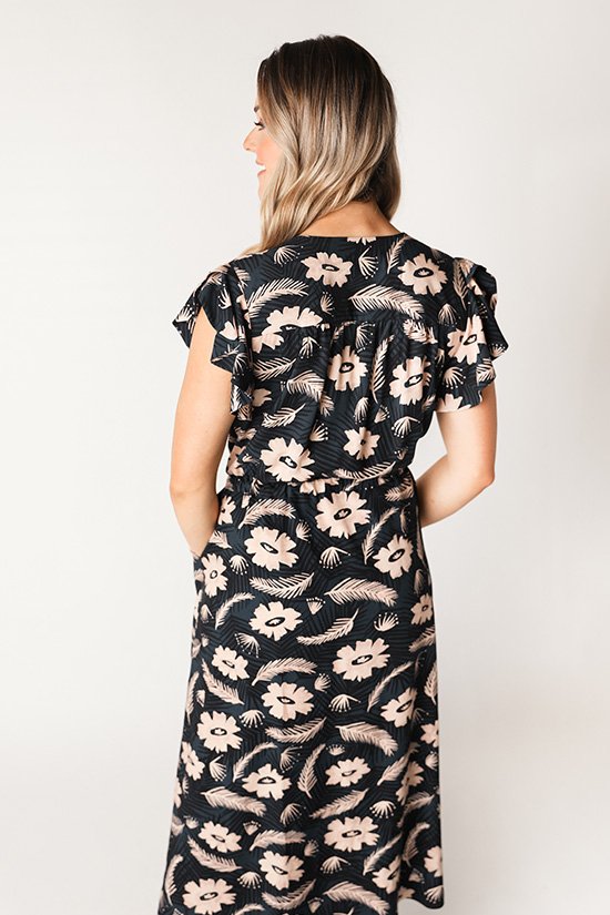 Chalk & Notch Orchid Midi Dress sewing pattern featuring wrap bodice, flowing midi skirt, and sleeve options with ruffle or long gathered sleeves.