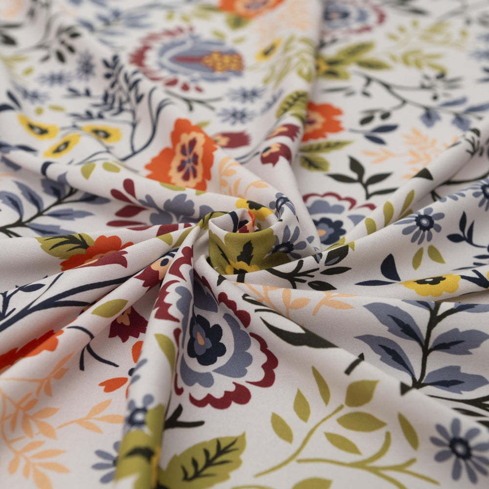 “Rayon Challis – Bright Floral fabric with white base and bold colorful floral print, lightweight and breathable 100% rayon, ideal for dresses, skirts, blouses, and scarves.”