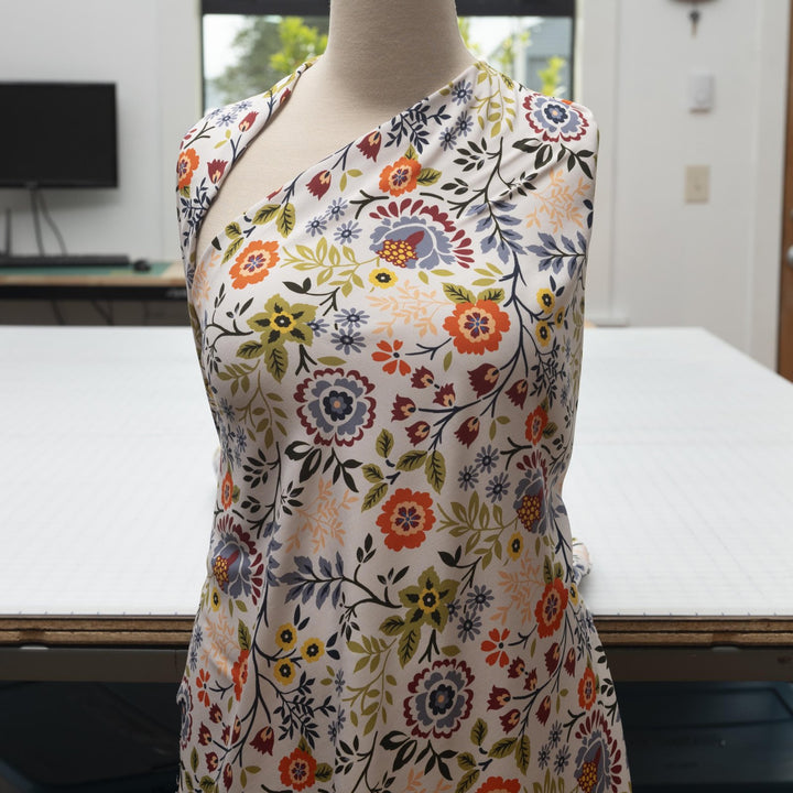 “Rayon Challis – Bright Floral fabric with white base and bold colorful floral print, lightweight and breathable 100% rayon, ideal for dresses, skirts, blouses, and scarves.”