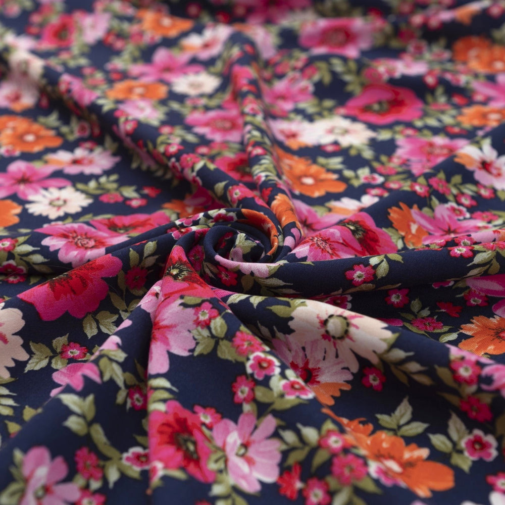 Rayon Challis Navy Floral Oasis medium-weight fabric with vibrant pink and blue florals on navy base