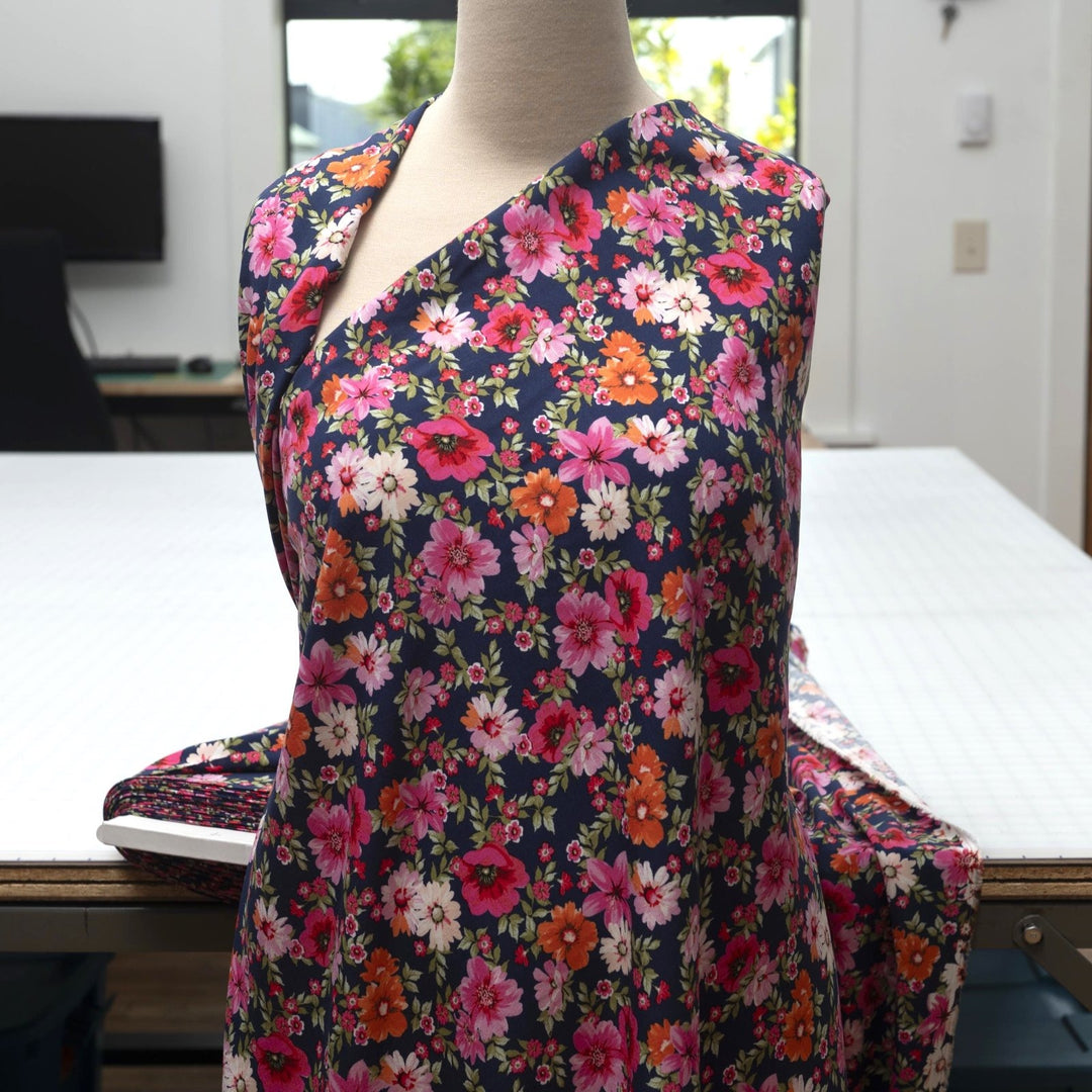 Rayon Challis Navy Floral Oasis medium-weight fabric with vibrant pink and blue florals on navy base