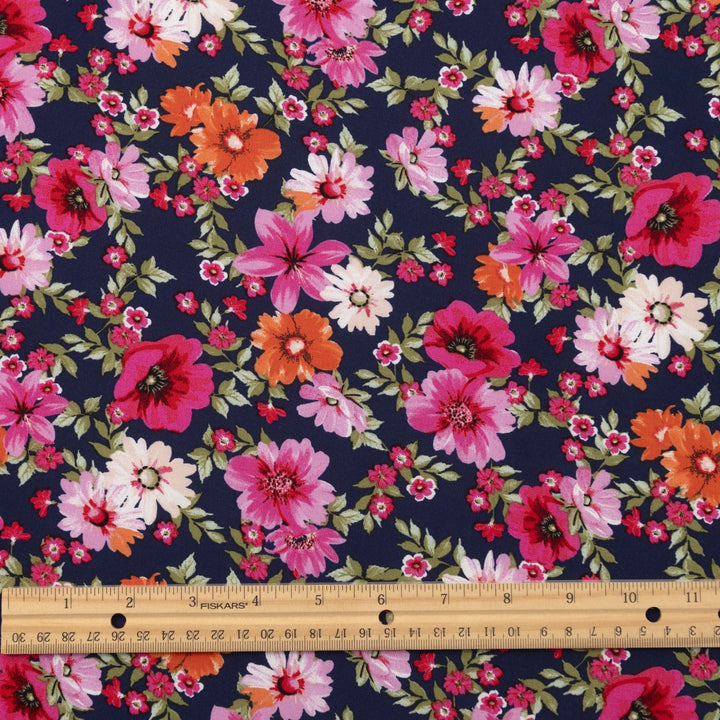 Rayon Challis Navy Floral Oasis medium-weight fabric with vibrant pink and blue florals on navy base