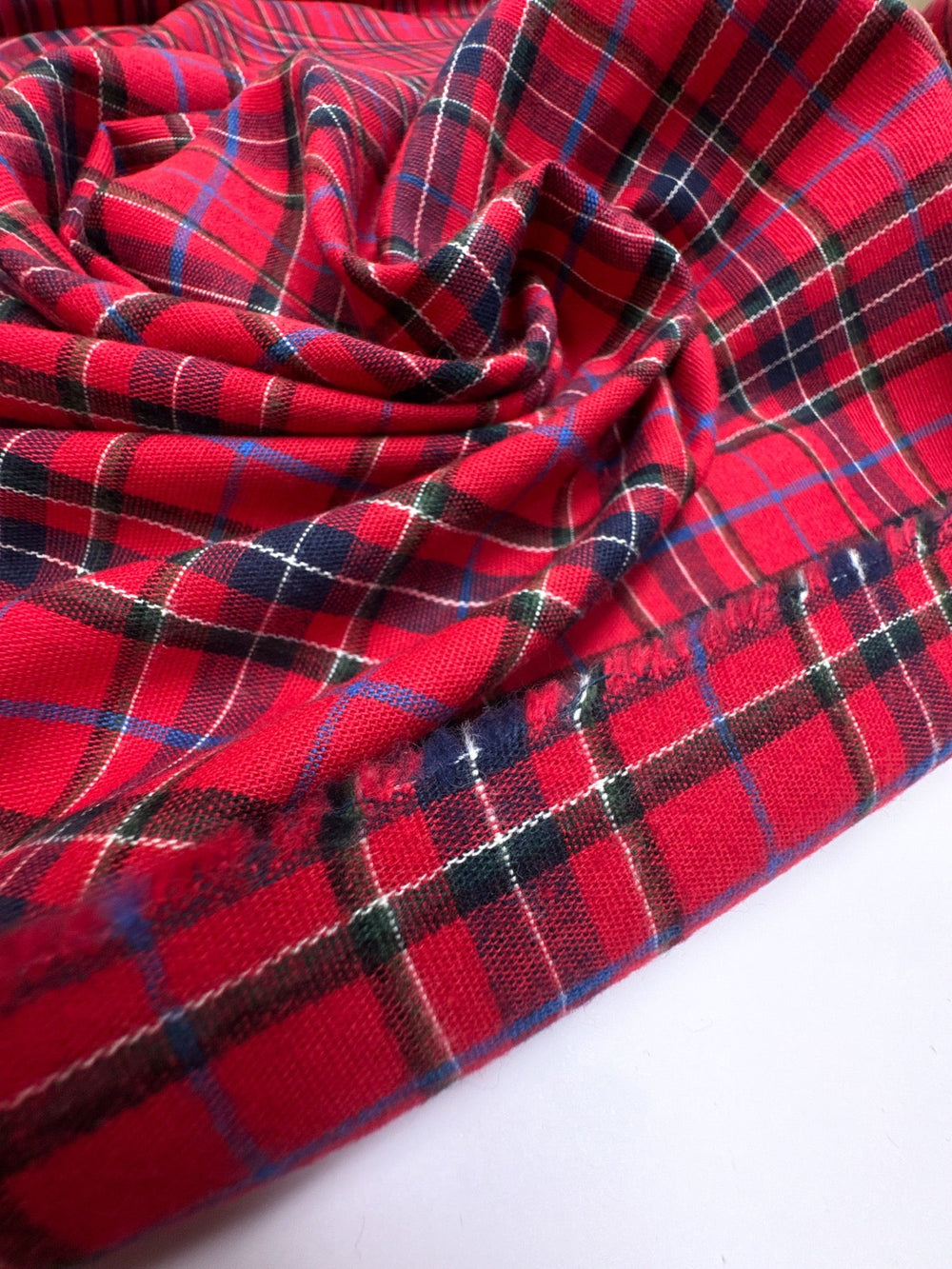 Italian cotton flannel fabric in bright red and black plaid, lightweight textile for shirts, blouses, and casual wear.