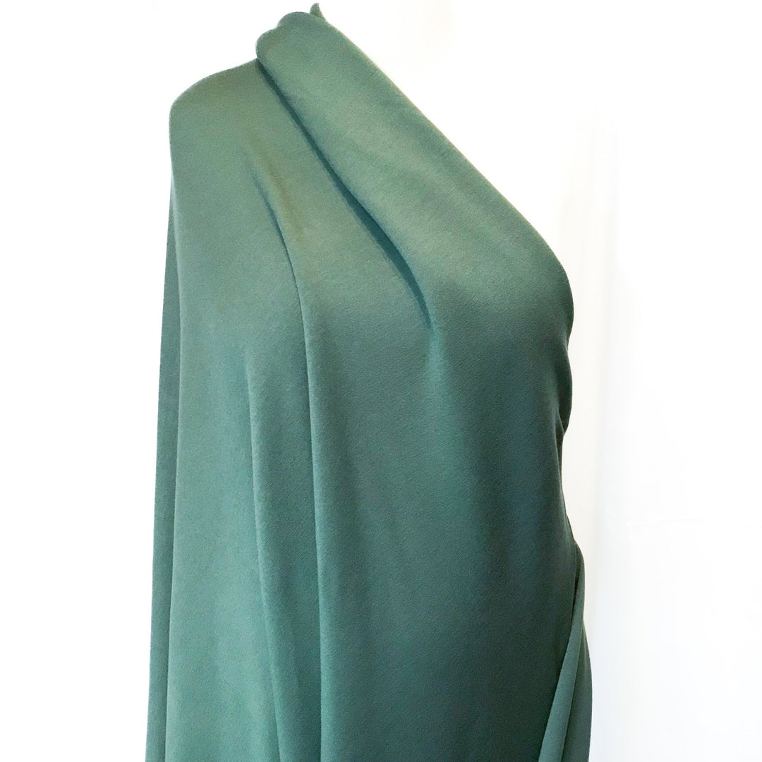 Deep olive sweatshirt fleece fabric with soft texture and rich color, perfect for cozy layered garments

