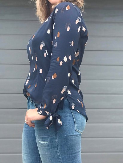 Sew to Grow Seoul Blossom Blouse with V-neck, curved back hem, side slits, and optional bow cuff.