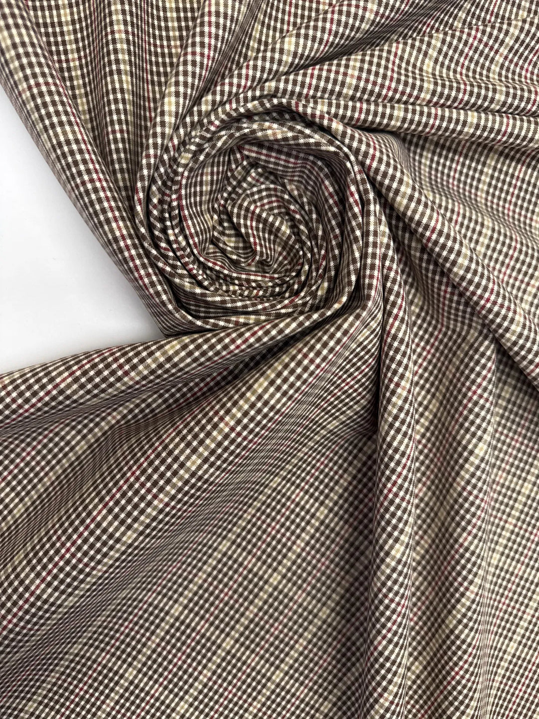 Close-up of brown and cream plaid Cotton Poplin fabric, made from 100% premium cotton, ideal for shirts and blouses.