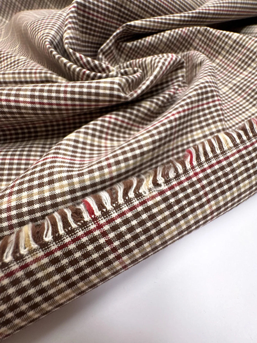 Close-up of brown and cream plaid Cotton Poplin fabric, made from 100% premium cotton, ideal for shirts and blouses.