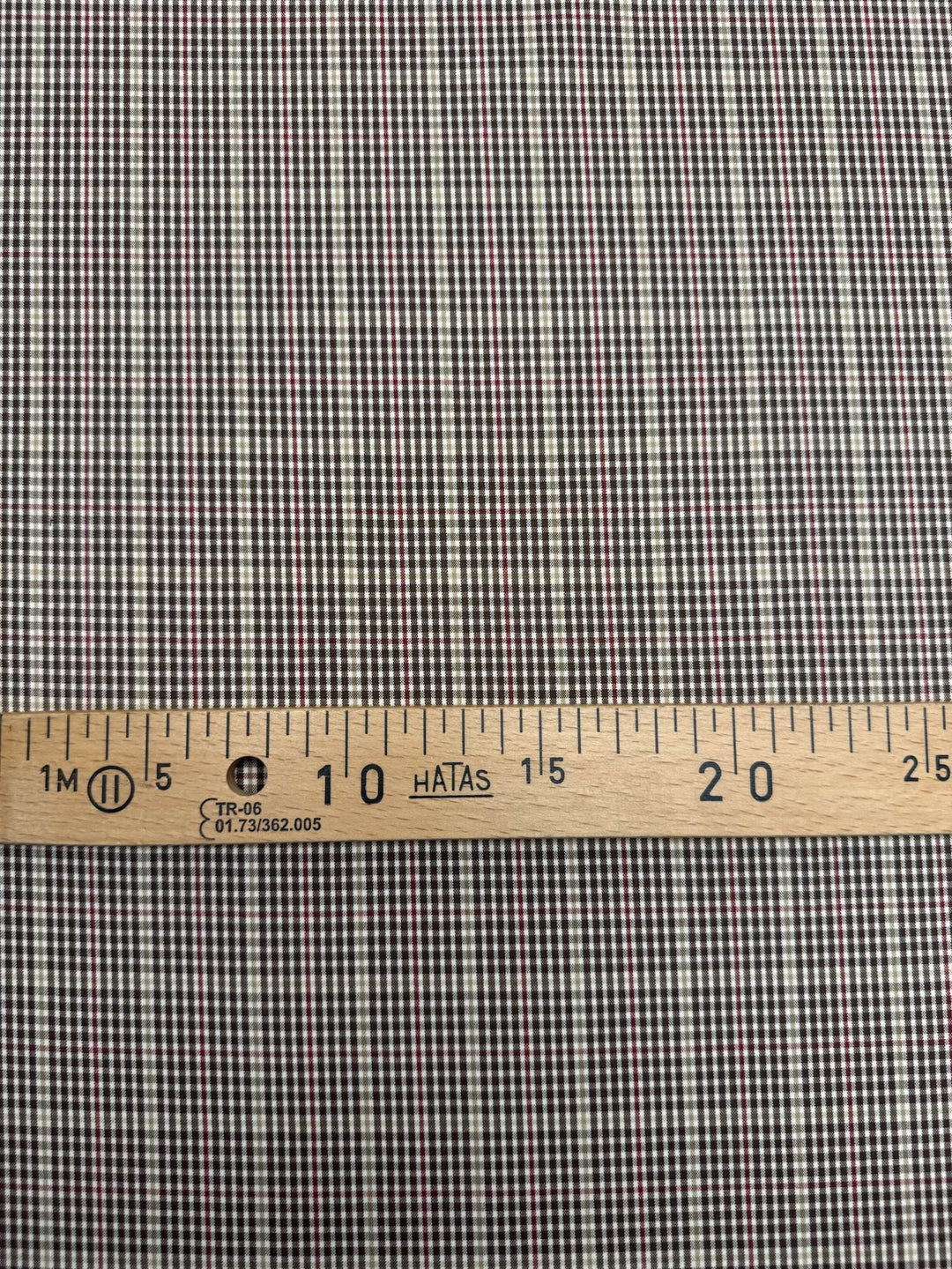 Close-up of brown and cream plaid Cotton Poplin fabric, made from 100% premium cotton, ideal for shirts and blouses.