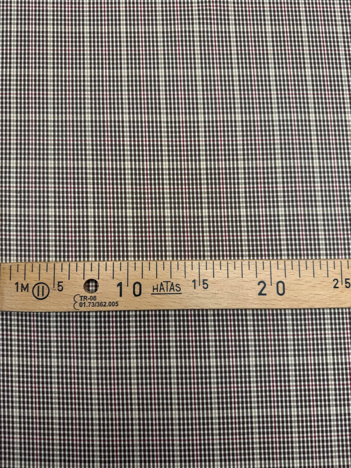 Close-up of brown and cream plaid Cotton Poplin fabric, made from 100% premium cotton, ideal for shirts and blouses.