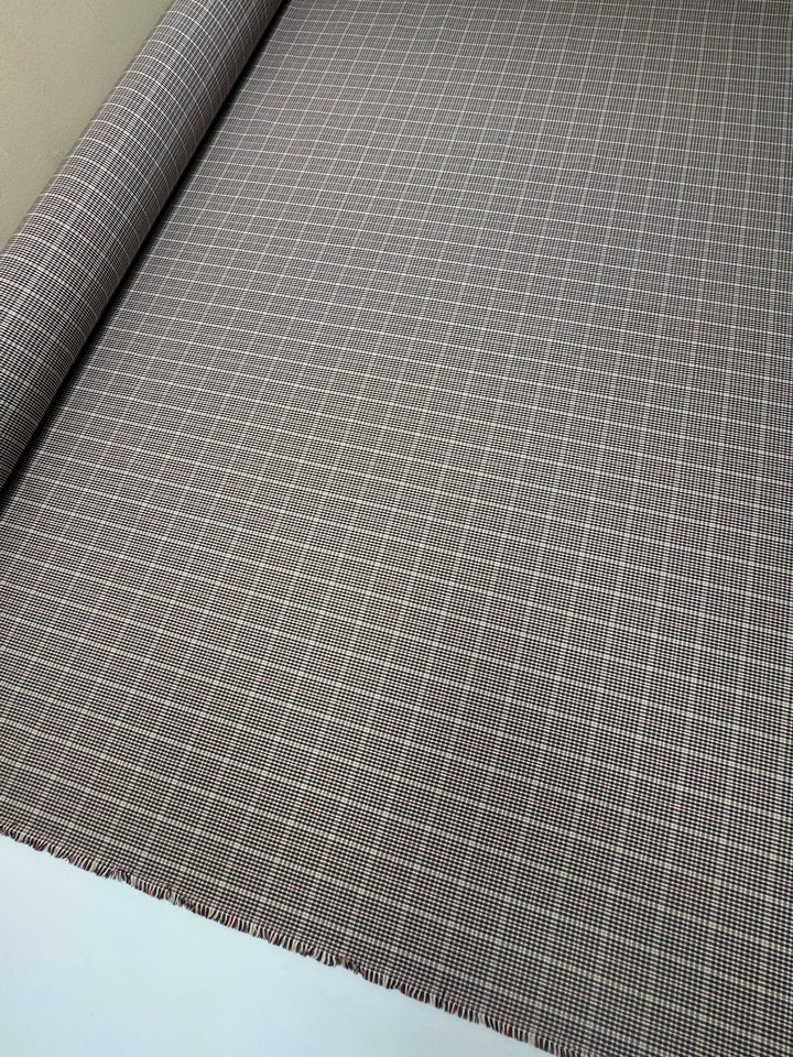 Close-up of brown and cream plaid Cotton Poplin fabric, made from 100% premium cotton, ideal for shirts and blouses.
