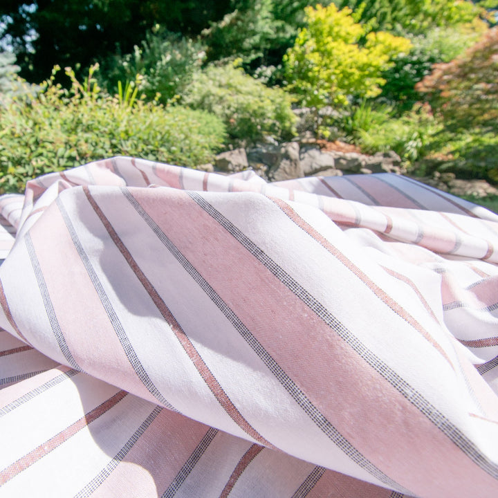 Pink and white yarn-dyed cotton chambray poplin fabric close-up texture