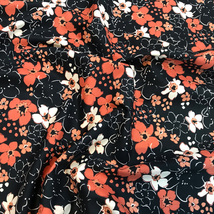 Fall floral cotton poplin fabric with orange blooms on black, 59-inch wide deadstock textile