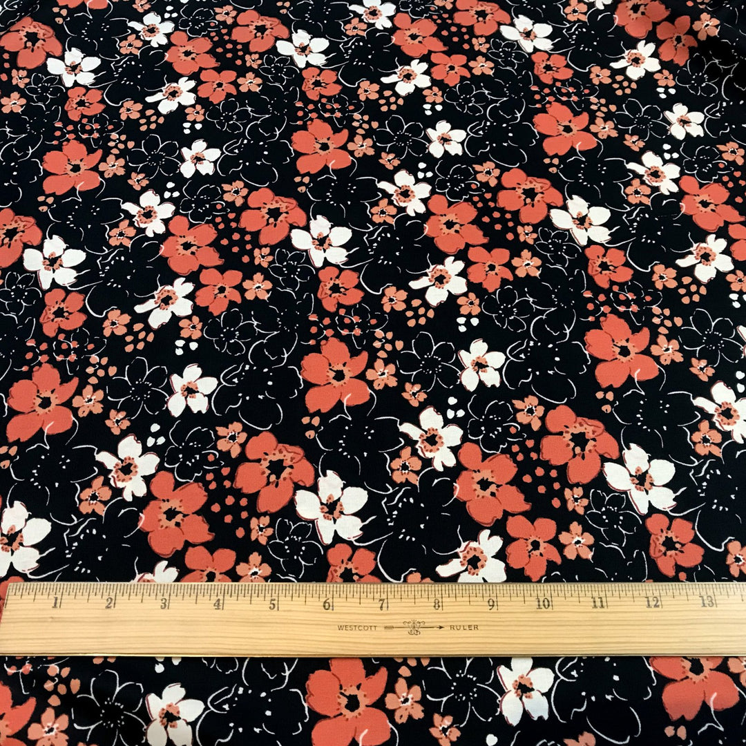 Fall floral cotton poplin fabric with orange blooms on black, 59-inch wide deadstock textile