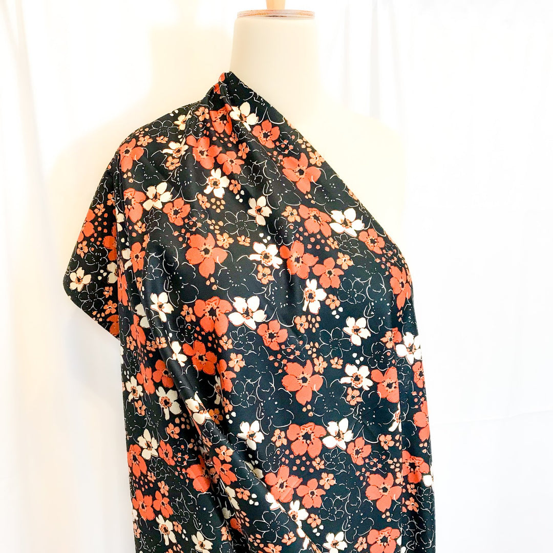 Fall floral cotton poplin fabric with orange blooms on black, 59-inch wide deadstock textile