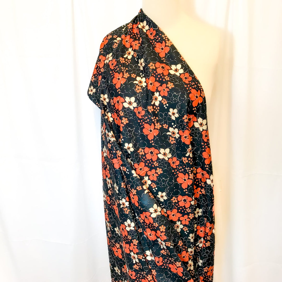 Fall floral cotton poplin fabric with orange blooms on black, 59-inch wide deadstock textile