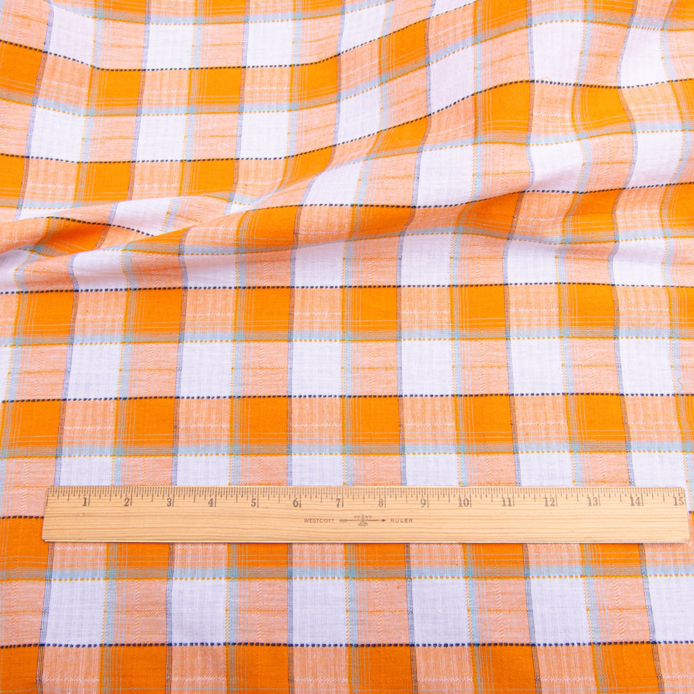 Orange and white plaid cotton shirting fabric close-up texture