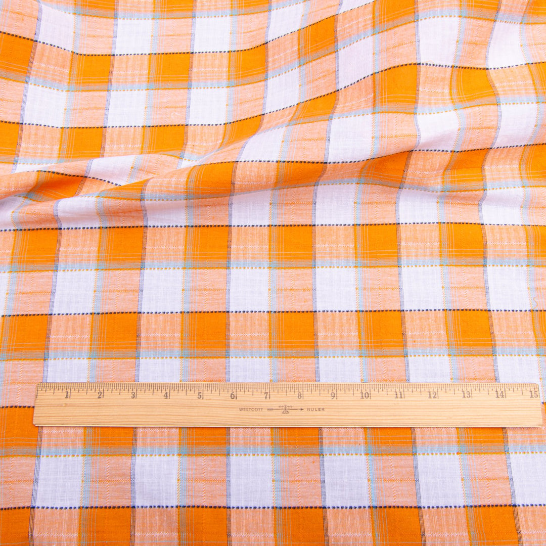 Orange and white plaid cotton shirting fabric close-up texture