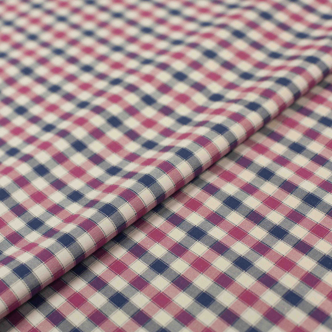 Lightweight Tattersall check cotton twill fabric in blue, pink, and cream