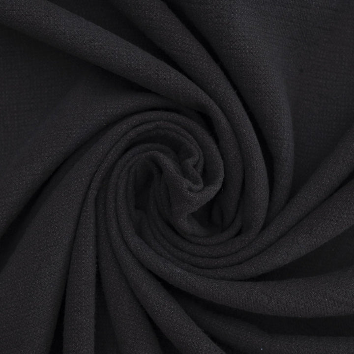 Crinkle Cotton Black 100% cotton fabric with textured finish for sewing pants, skirts, and dresses