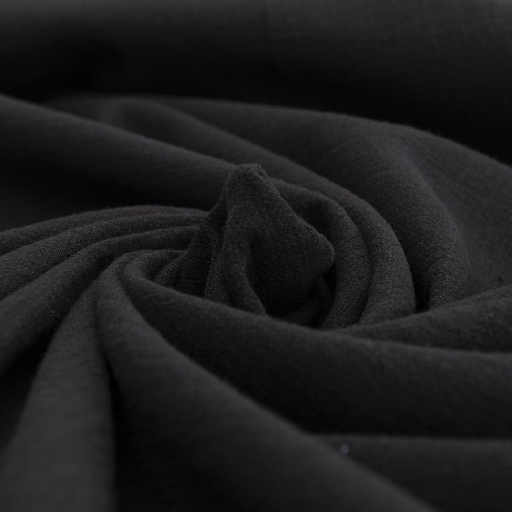 Crinkle Cotton Black 100% cotton fabric with textured finish for sewing pants, skirts, and dresses