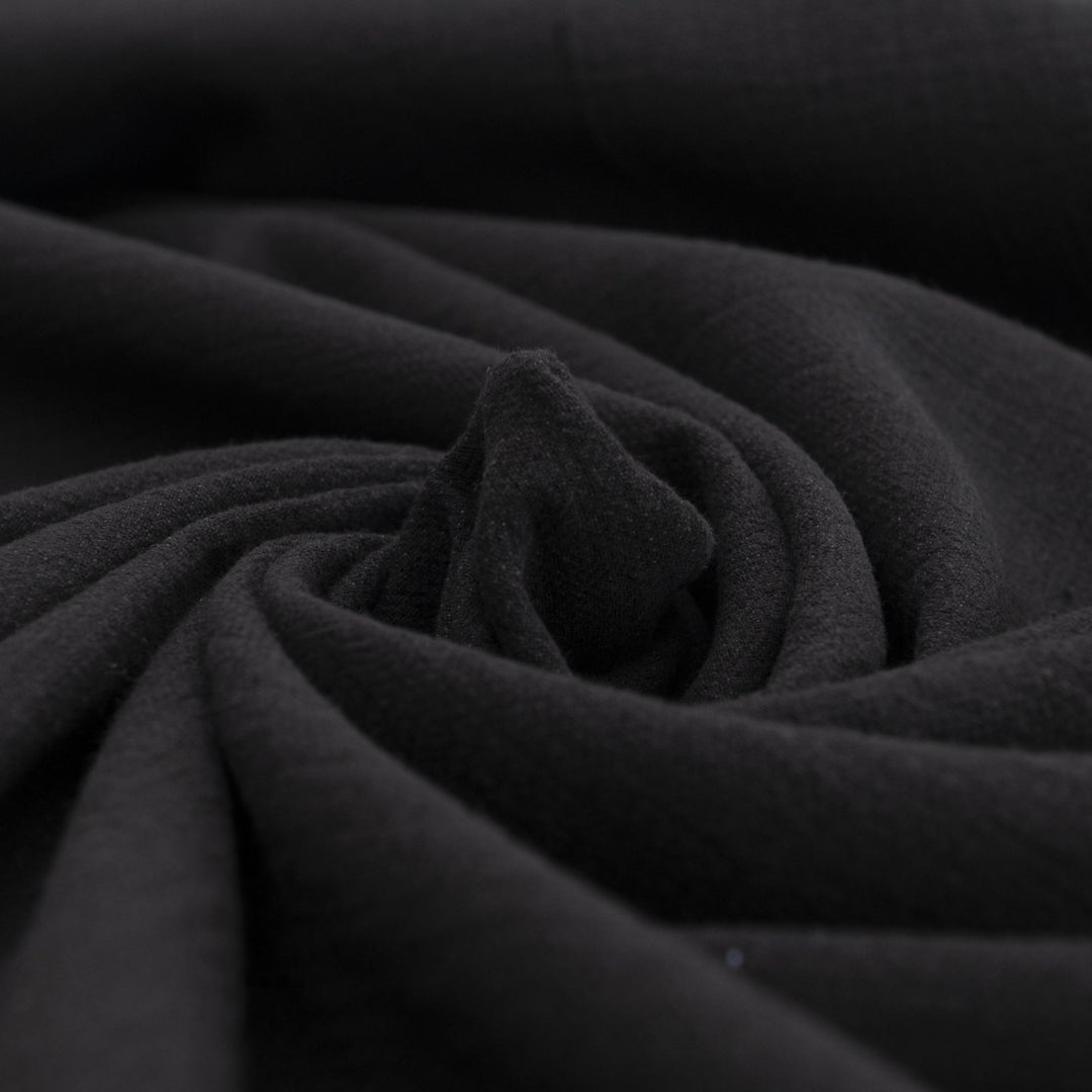 Crinkle Cotton Black 100% cotton fabric with textured finish for sewing pants, skirts, and dresses