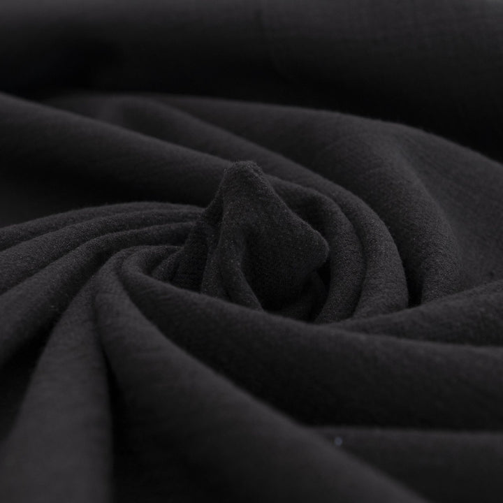 Crinkle Cotton Black 100% cotton fabric with textured finish for sewing pants, skirts, and dresses