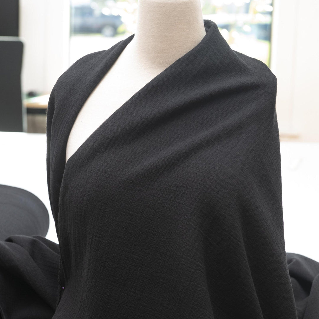 Crinkle Cotton Black 100% cotton fabric with textured finish for sewing pants, skirts, and dresses