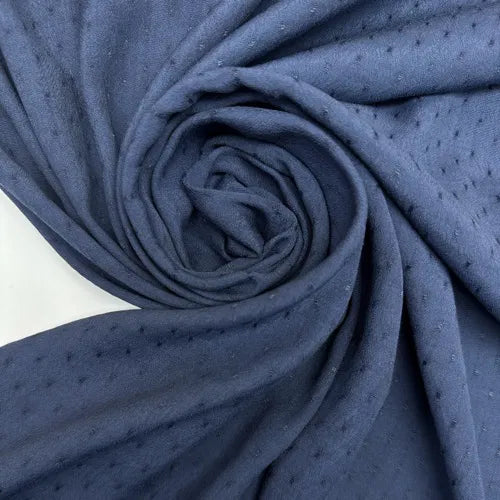 Close-up of Dressweight Twill fabric in textured blue, made from a premium blend of 75% Viscose/Rayon and 25% Cotton, perfect for stylish shirts and blouses.